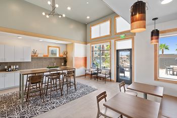A modern kitchen with a dining table and chairs.